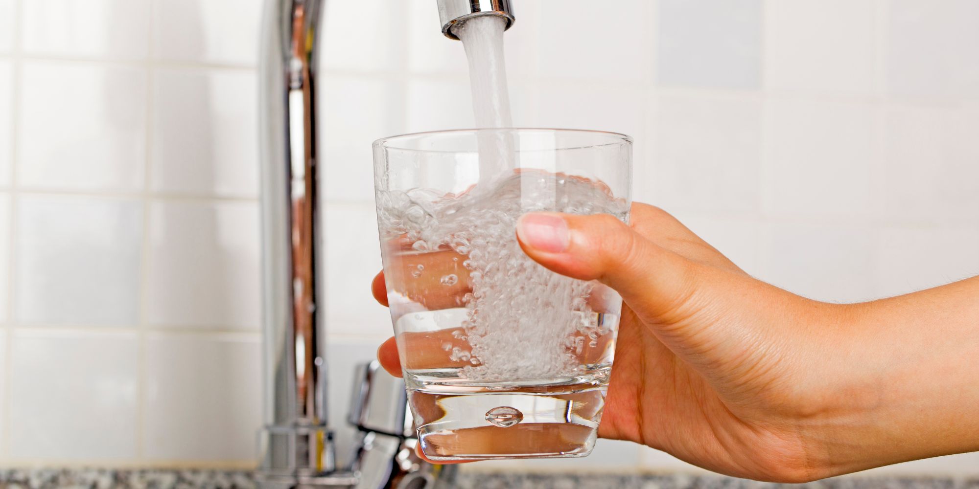 glass being filled with water hydration for the elderly