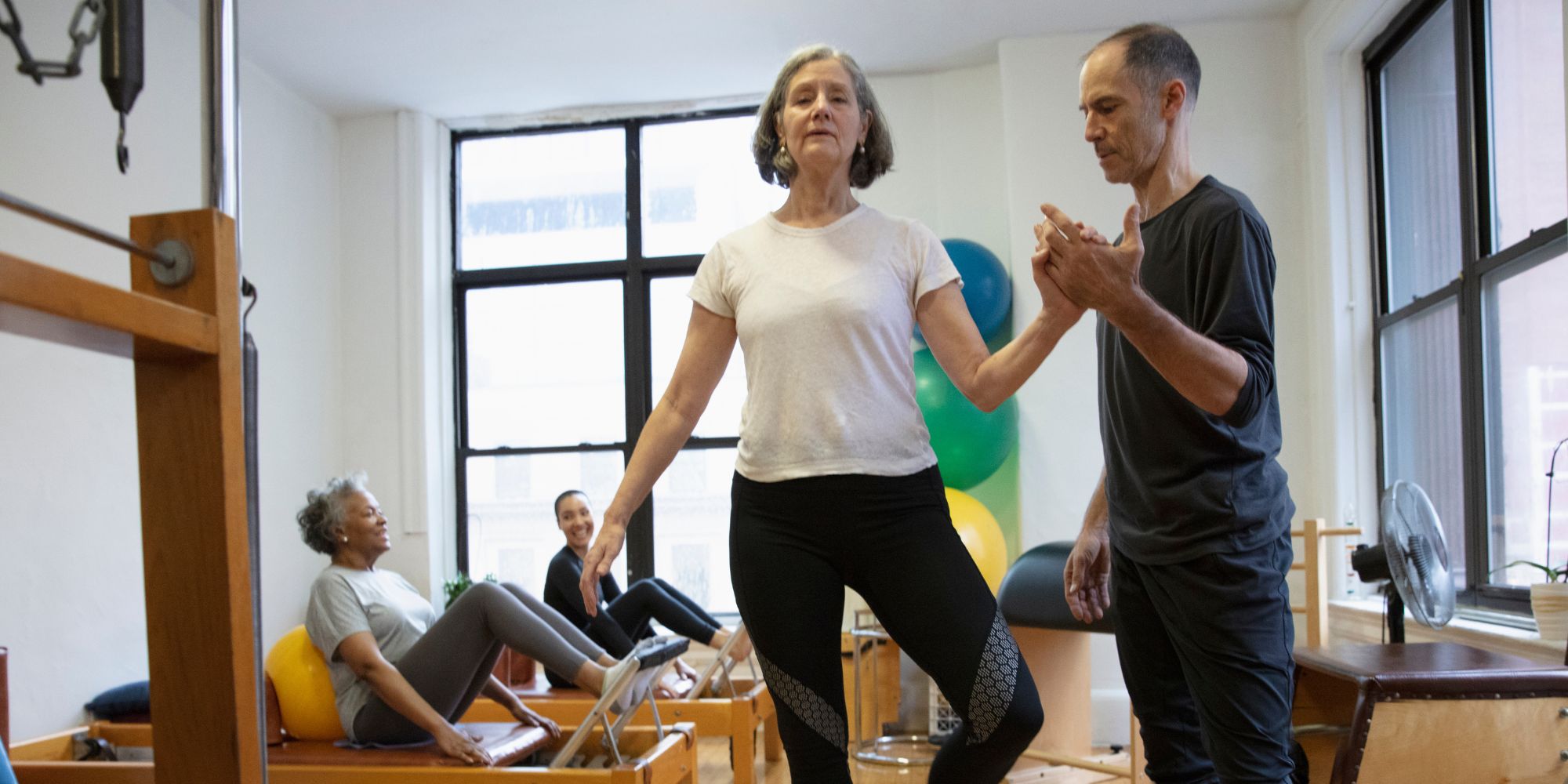 elderly woman doing pilates in class pilates for seniors