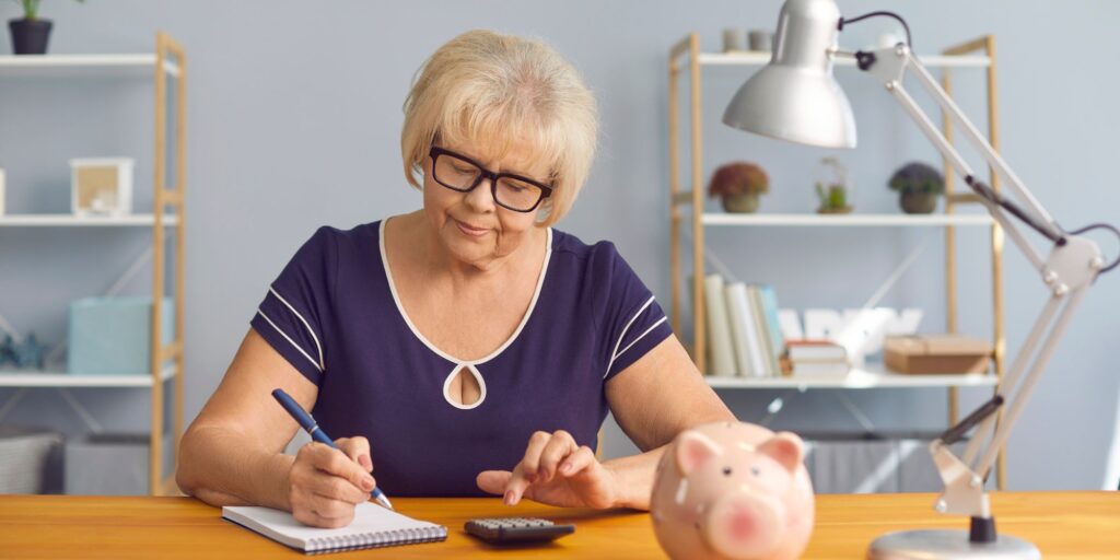 older lady working out budget money saving tips for seniors